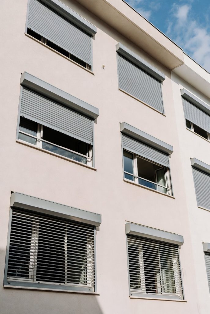 motorized roller shutter with tubular motor installed on residential window for security and shading